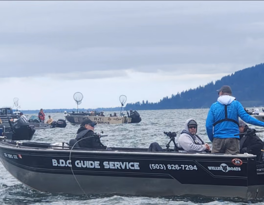 The BDC Guide Service sled under way on open water with other boats behind it