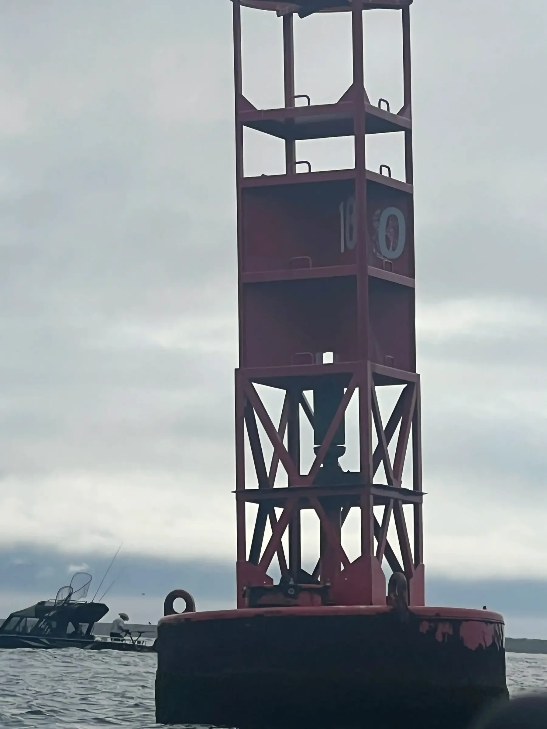 Red channel marker buoy on the water