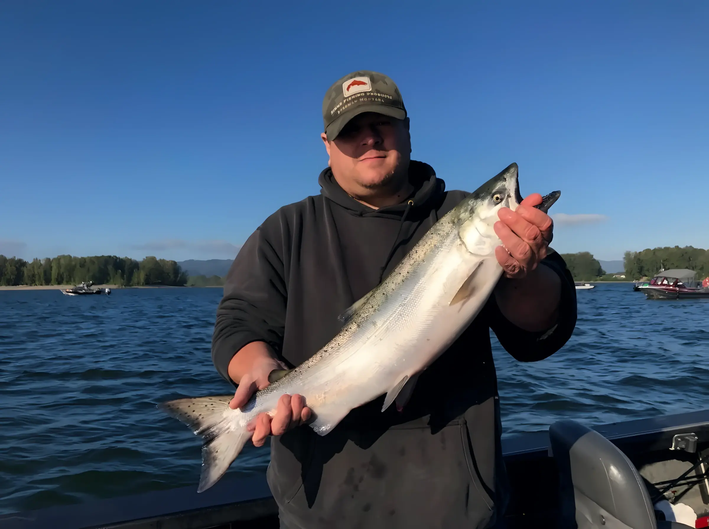Angler holding a large fish on a boat