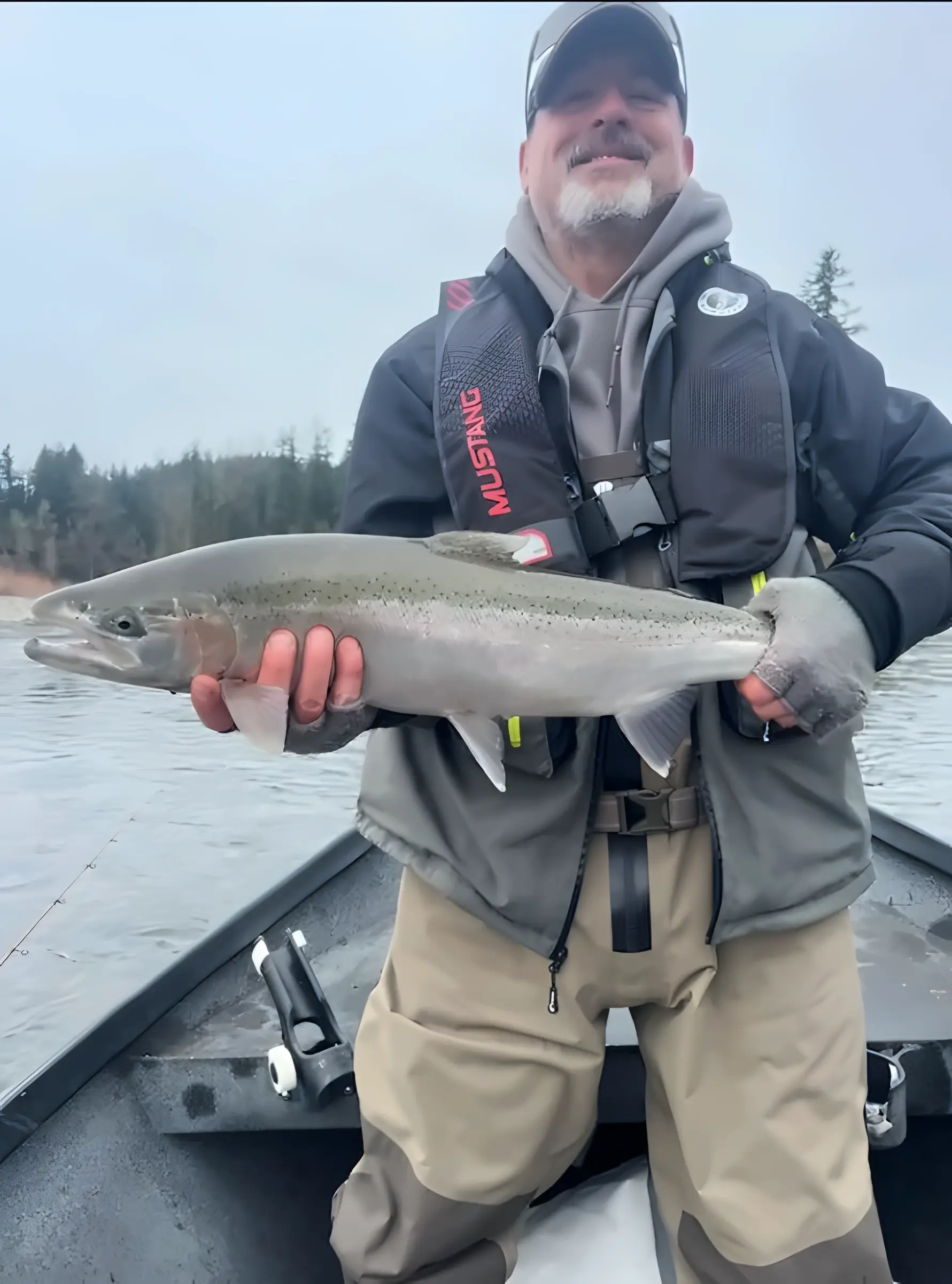 Angler holding a fish on a boat